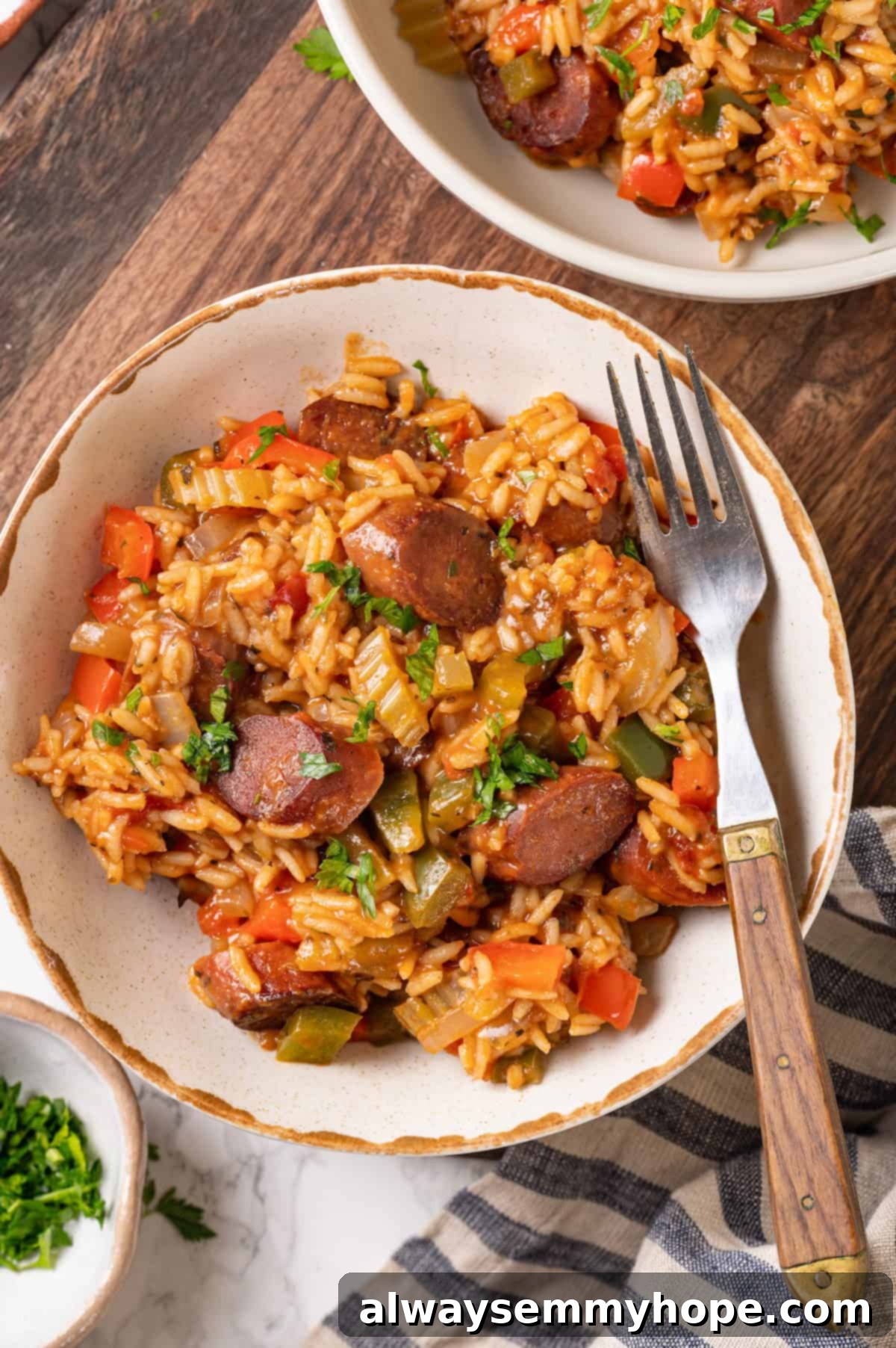 Vegan jambalaya recipe is comfort food Cajun style! With rice, veggies and plant-based sausage, this is a meal that’s flavourful and hearty. Overhead view of vegan jambalaya in bowl, showcasing its rich colors and textures