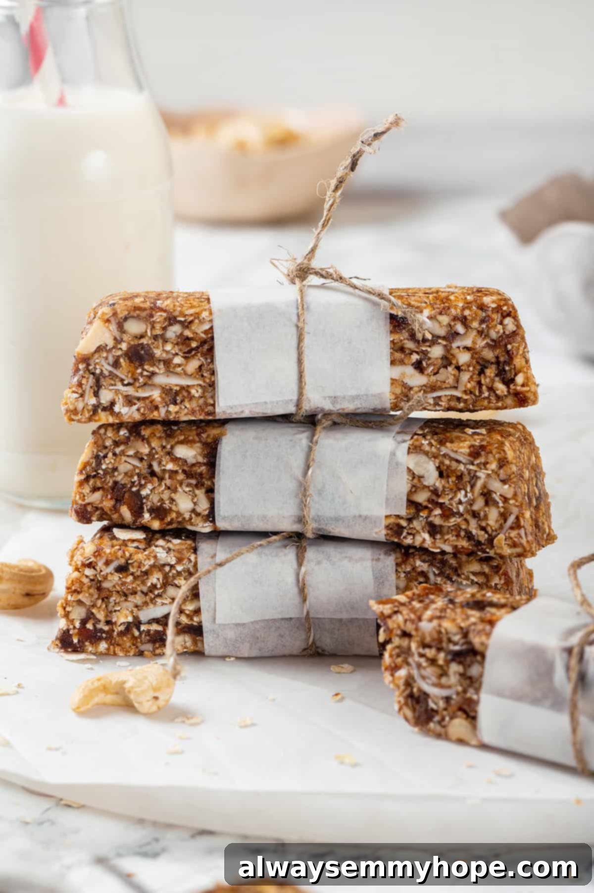 Stack of 3 homemade granola bars wrapped in parchment and twine