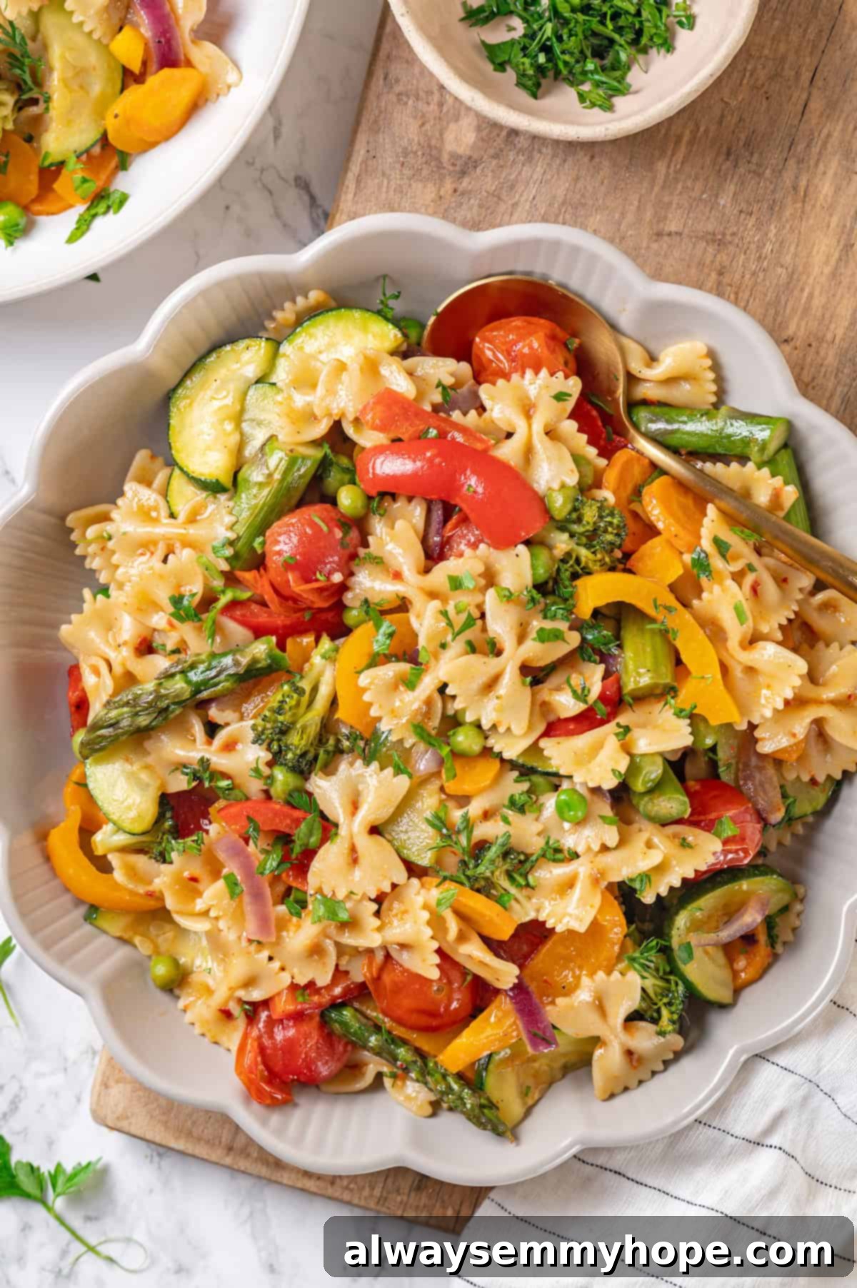 A delicious bowl of roasted vegetable vegan pasta primavera with a fork