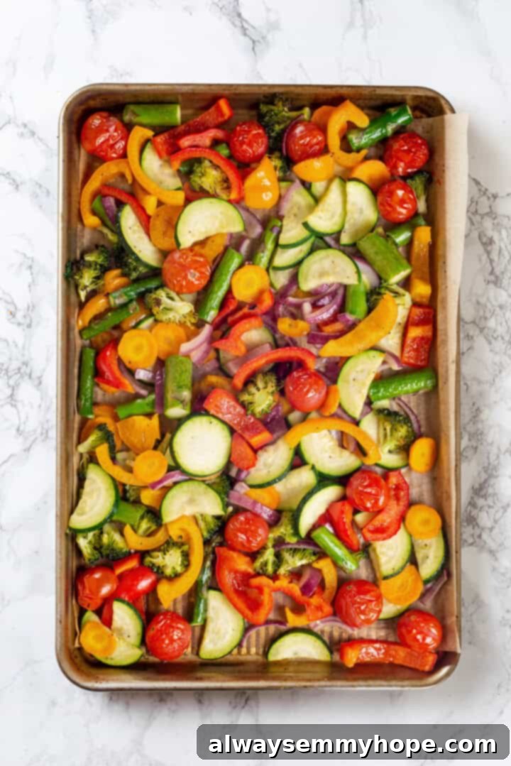 Overhead view of perfectly roasted vegetables on a sheet pan, tender and slightly caramelized