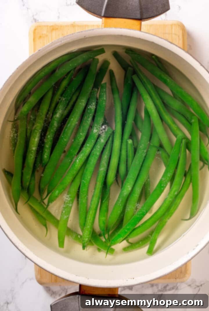 Overhead view of haricot vert cooking in water