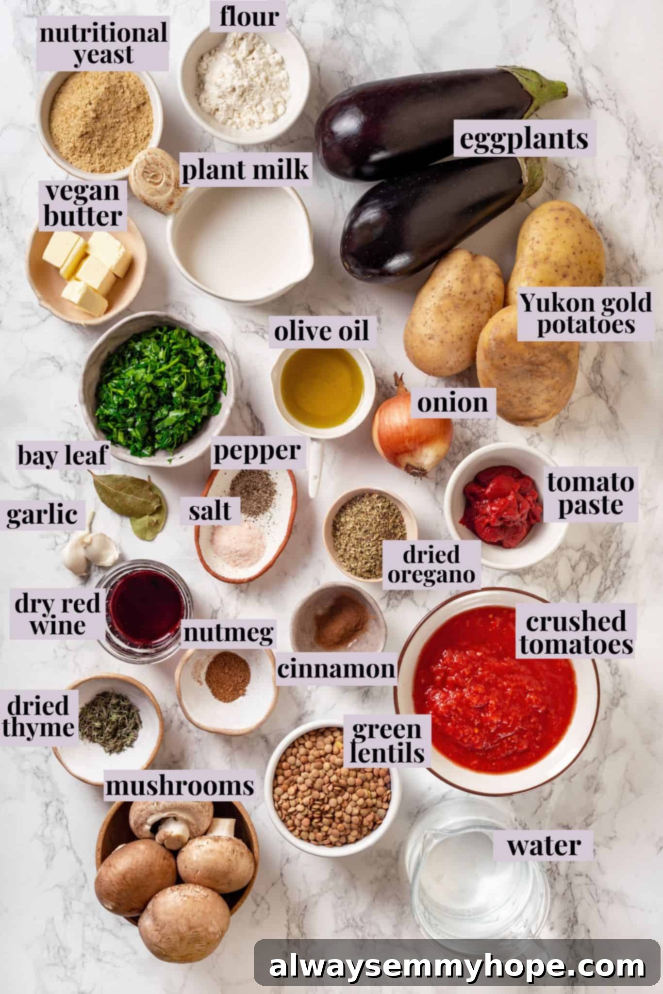 This vegan moussaka recipe has all the flavour of the classic Greek eggplant dish, but with tender lentils and mushrooms replacing the meat! Overhead view of ingredients for vegan moussaka with labels