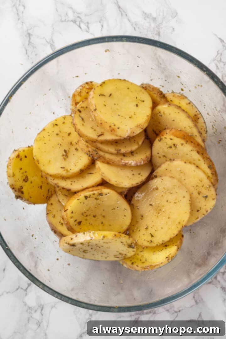 This vegan moussaka recipe has all the flavour of the classic Greek eggplant dish, but with tender lentils and mushrooms replacing the meat! Overhead view of potato slices in bowl