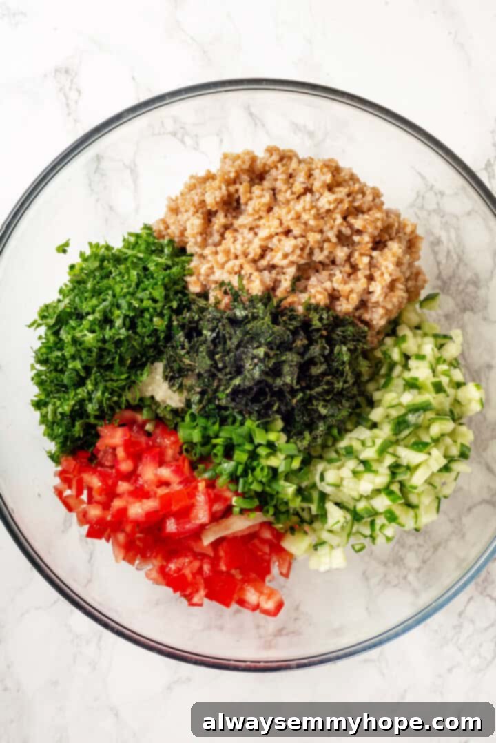 Overhead view of tabbouleh ingredients in mixing bowl, ready to be tossed