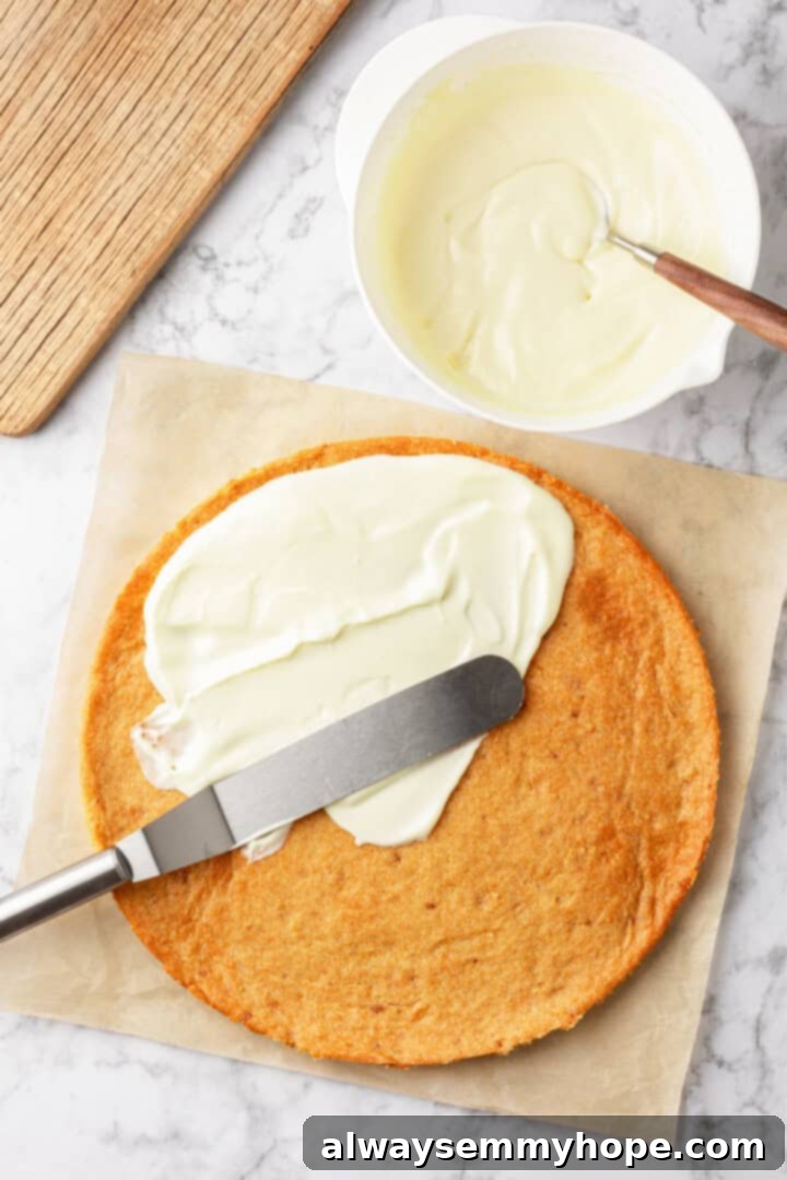 Spreading frosting onto sugar cookie crust for fruit pizza