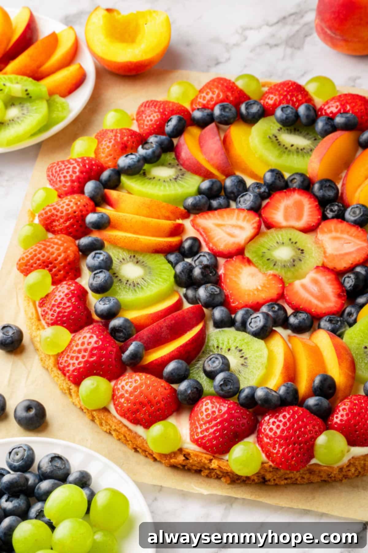 Whole fruit pizza on parchment paper