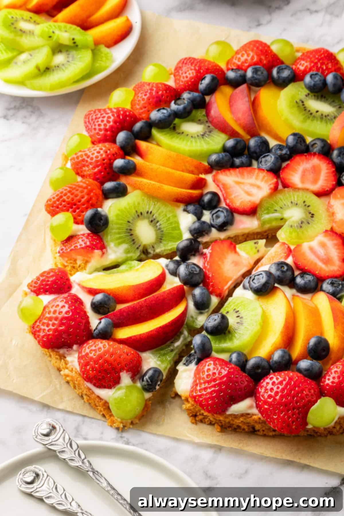 Fruit pizza with slice cut and pulled out slightly