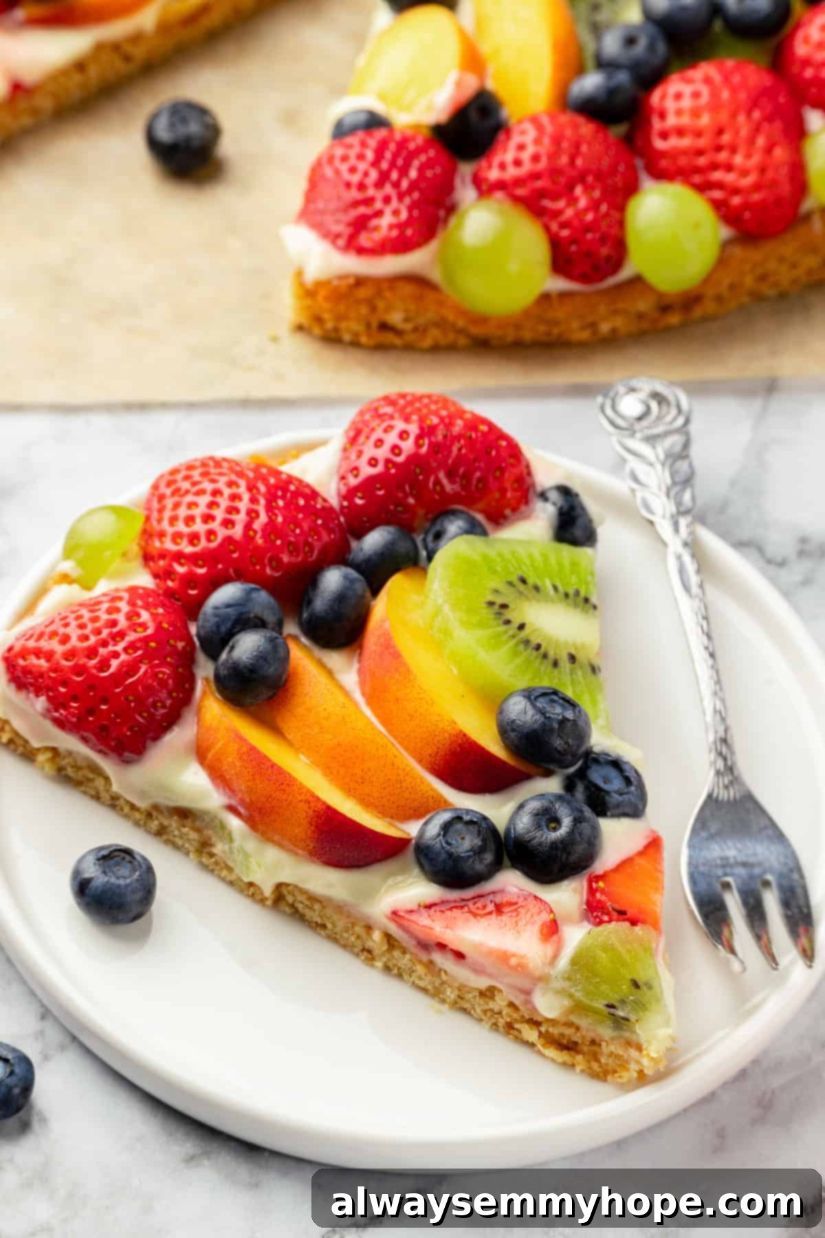 Slice of fruit pizza on plate with fork