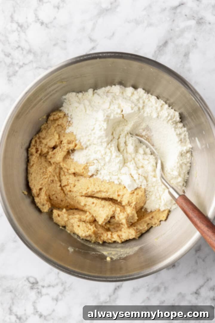Dry ingredients added to wet ingredients in mixing bowl