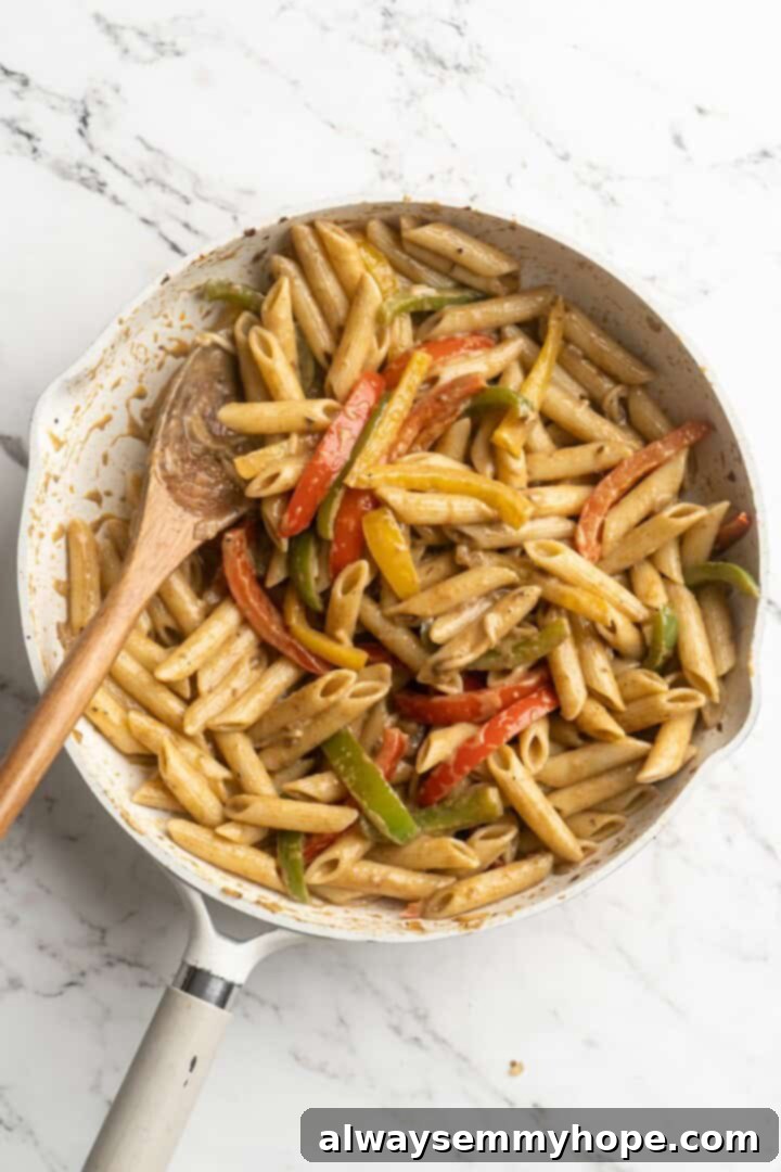 Overhead view of the finished Rasta Pasta in a skillet, perfectly sauced and ready to serve.