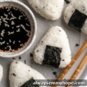 A delectable plate of vegan onigiri with chickpea tuna filling and nori, showcasing a perfect balance of Japanese flavors and textures.