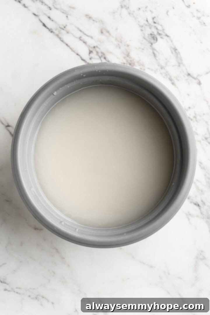 A bowl of cloudy water, showing the initial rinse of sushi rice to remove excess starch.