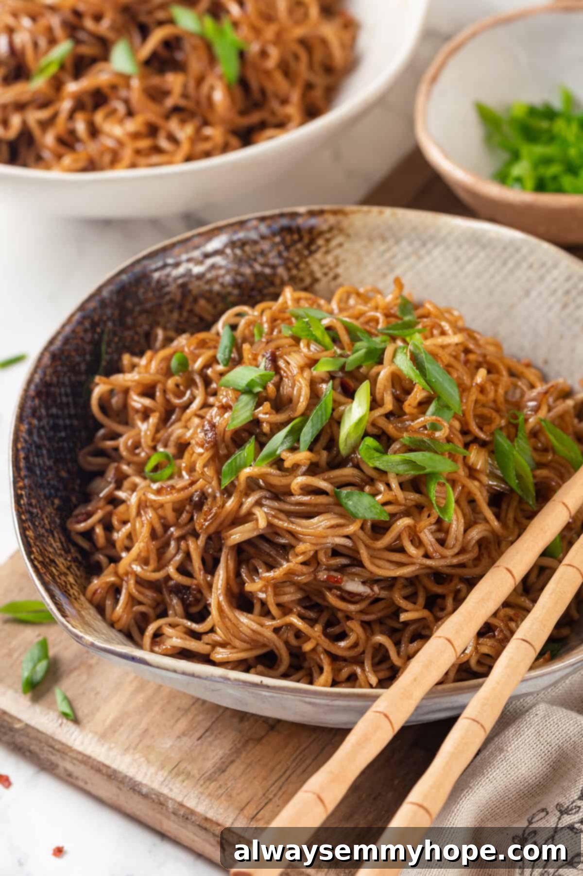 This spicy ramen recipe is an easy budget-friendly dinner that's packed with flavour! Sweet, spicy and umami—and it takes minutes to make! Spicy ramen in bowl garnished with green onions