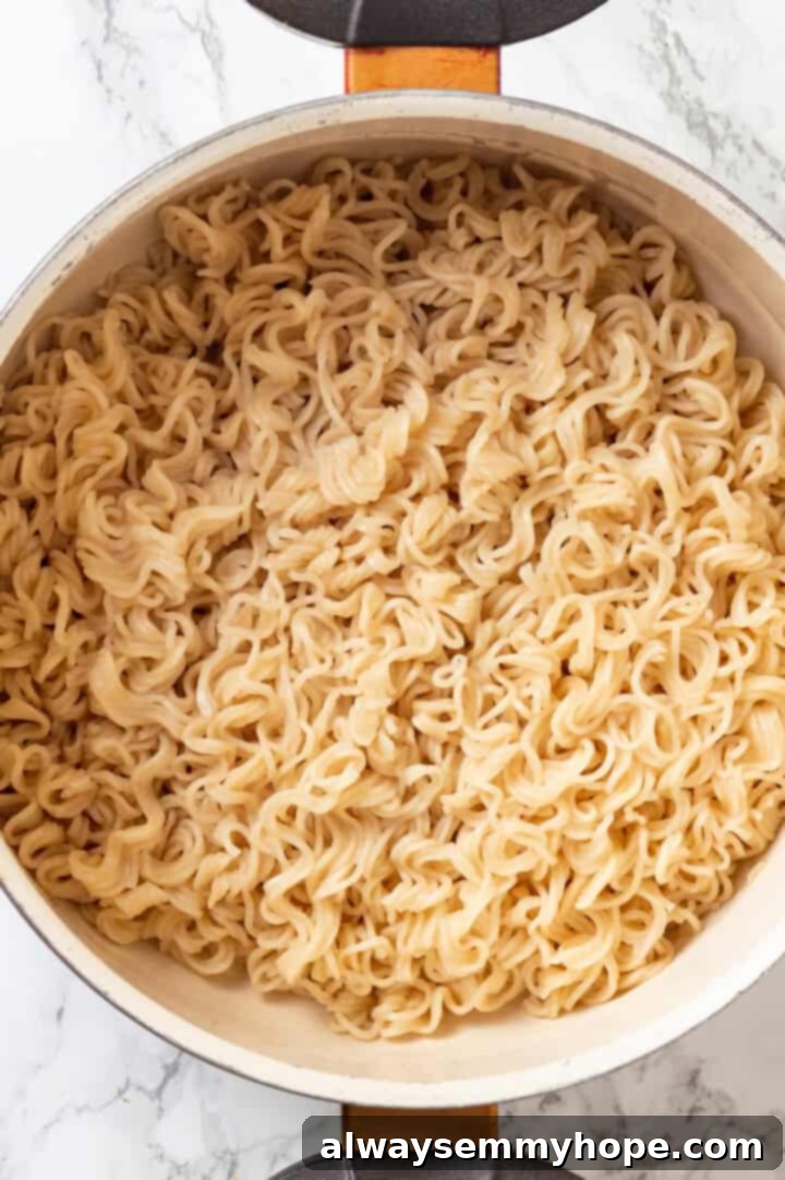 This spicy ramen recipe is an easy budget-friendly dinner that's packed with flavour! Sweet, spicy and umami—and it takes minutes to make! Overhead view of cooked ramen noodles