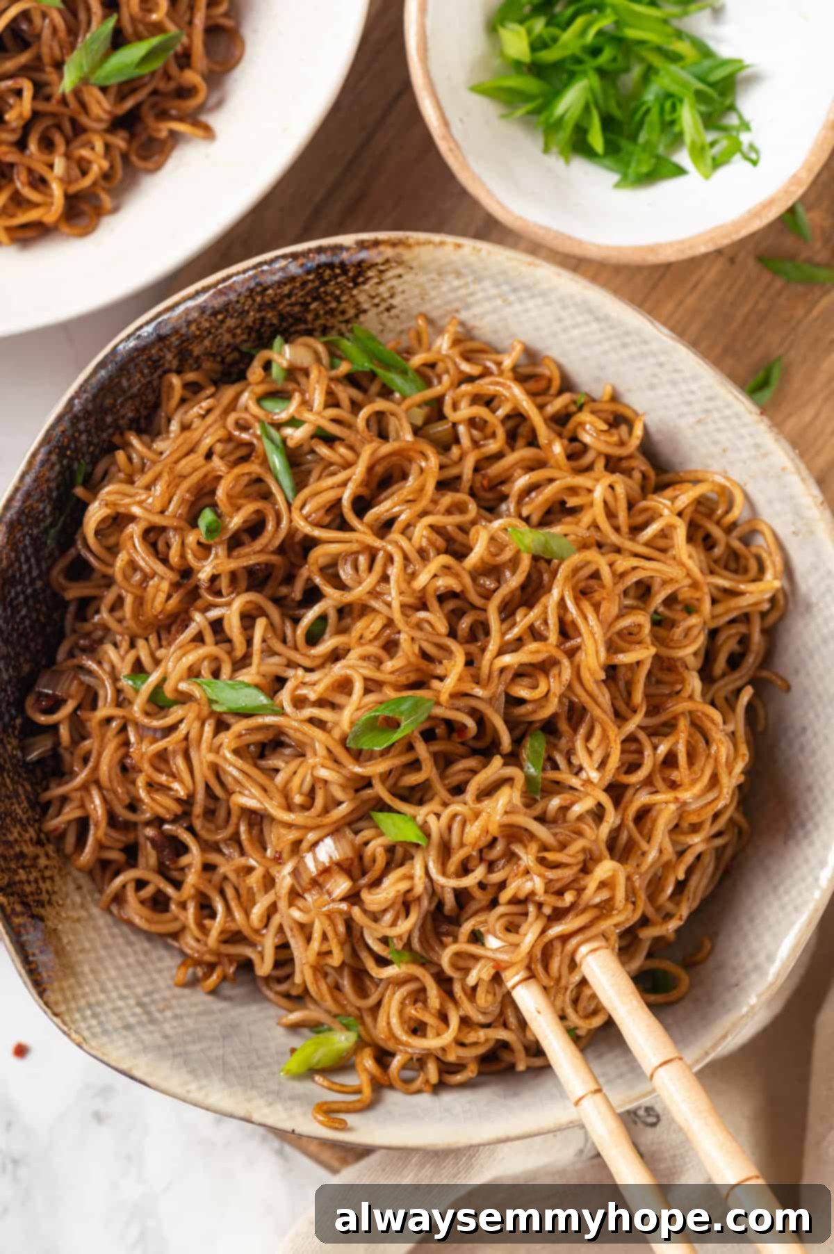 This spicy ramen recipe is an easy budget-friendly dinner that's packed with flavour! Sweet, spicy and umami—and it takes minutes to make! Overhead view of spicy ramen in bowl with chopsticks