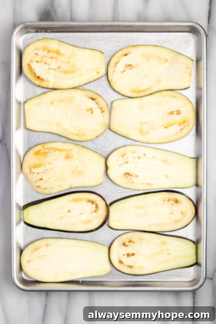 Overhead view of eggplant slices on baking sheet for eggplant rollatini