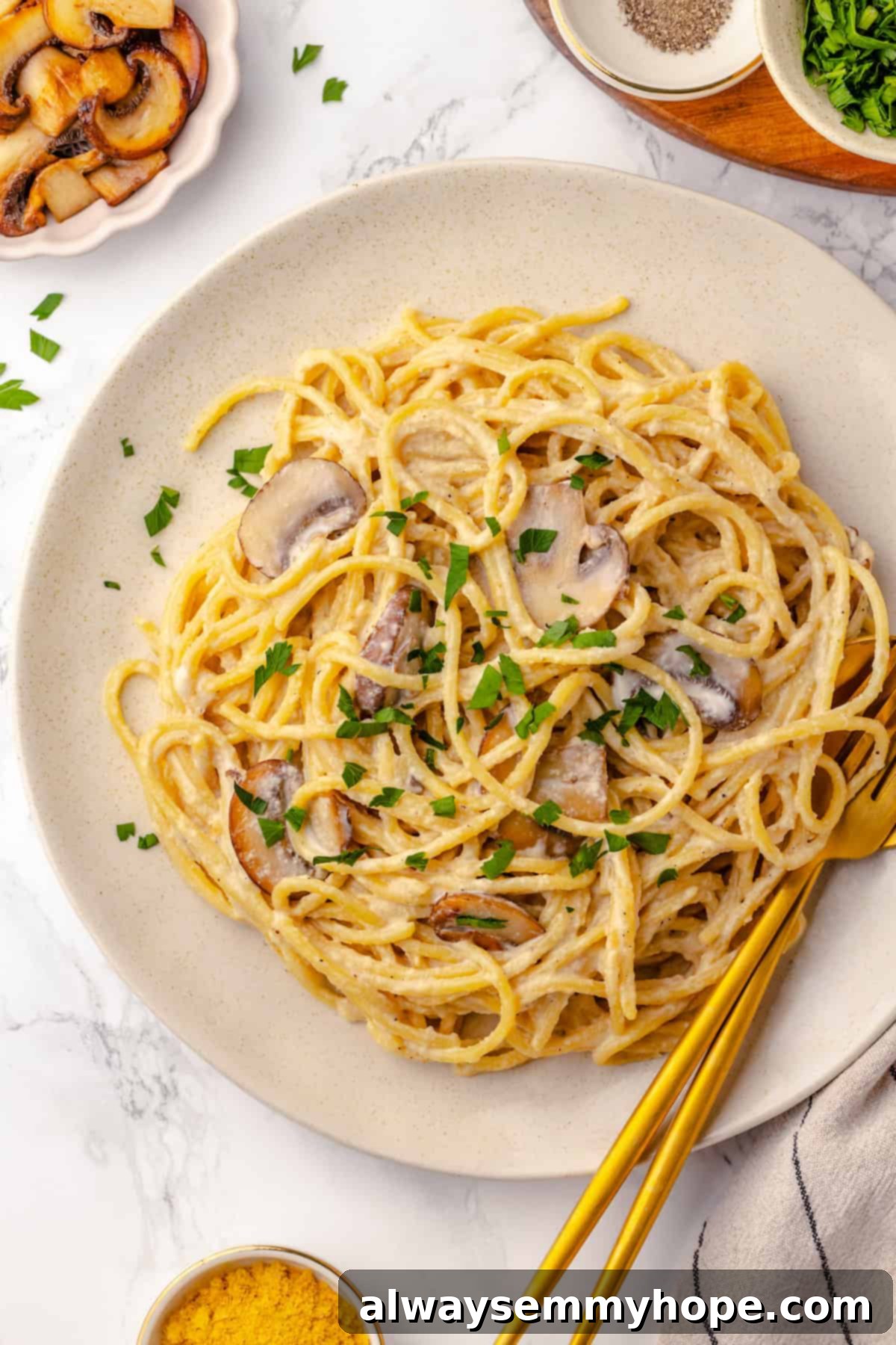 This creamy vegan pasta carbonara is a delicious plant-based alternative to the traditional recipe with mushrooms standing in for the meat! Overhead view of pasta carbonara on plate