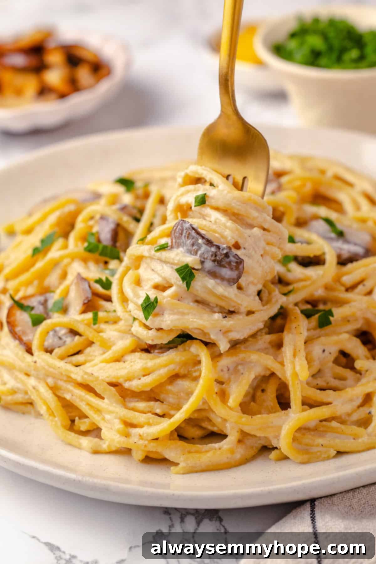 This creamy vegan pasta carbonara is a delicious plant-based alternative to the traditional recipe with mushrooms standing in for the meat! Twirling pasta carbonara onto fork