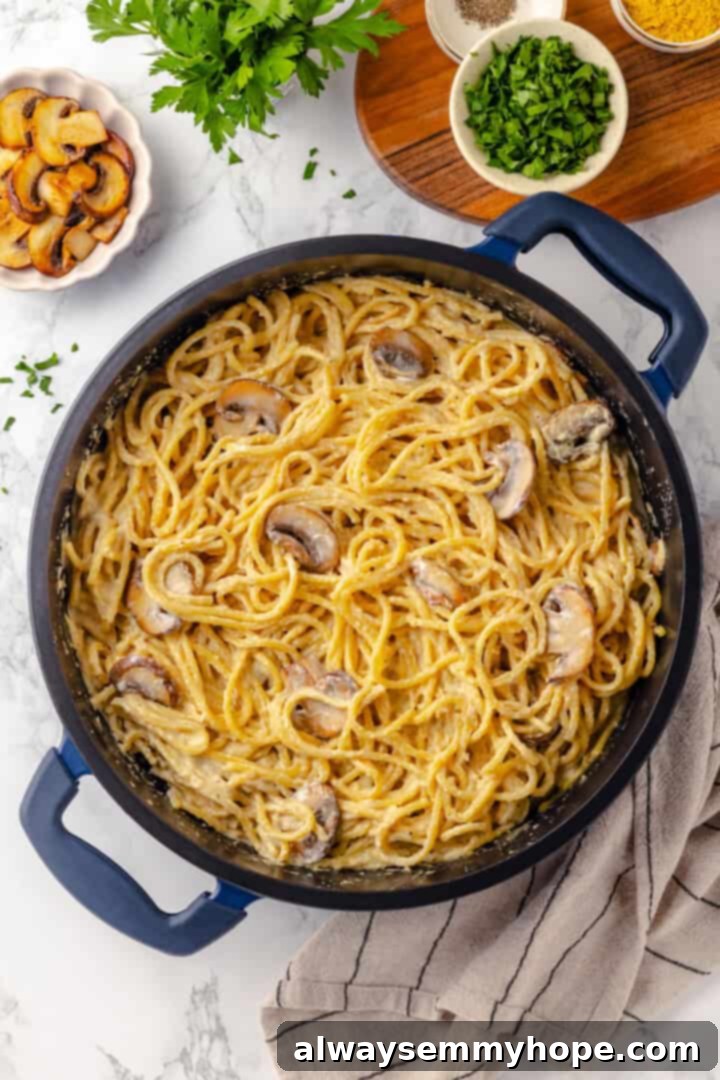 This creamy vegan pasta carbonara is a delicious plant-based alternative to the traditional recipe with mushrooms standing in for the meat! Overhead view of vegan pasta carbonara in skillet
