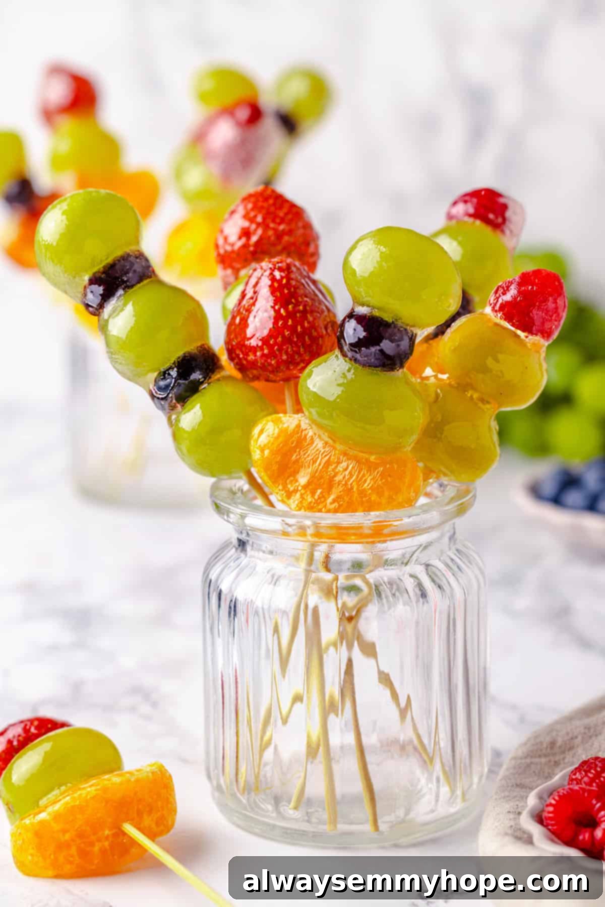 Tanghulu is one part fruit, one part candy and entirely delicious! Fruit skewers dipped in candy coating to create a sweet, crunchy shell. Skewers of tanghulu in jar