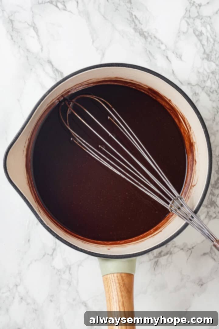 Liquid ingredients for no bake cookies in pan with whisk