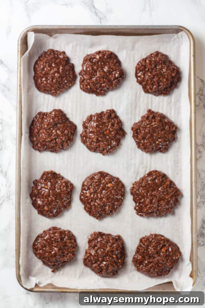 Overhead view of no bake cookies on parchment-lined baking sheet