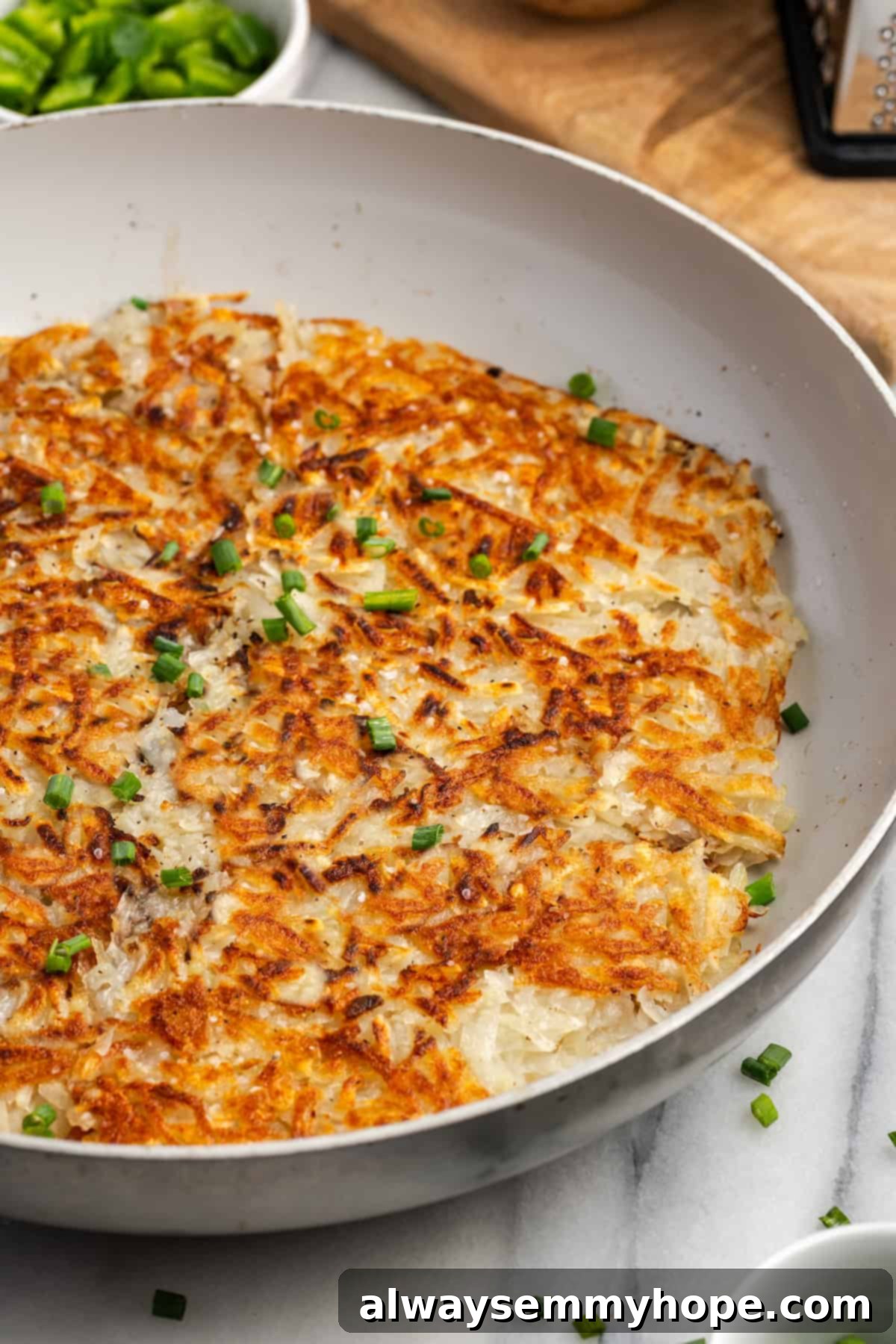 A large skillet filled with beautifully cooked, crispy, golden-brown hash browns, indicating a successful recipe.