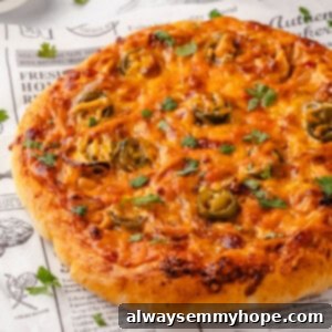 Birria Pizza Sensation 2 Unsliced birria pizza on marble board