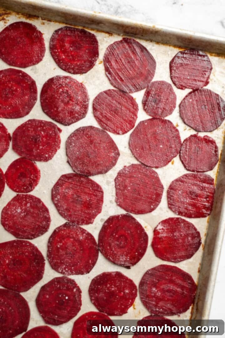 Overhead view of raw beets on sheet pan