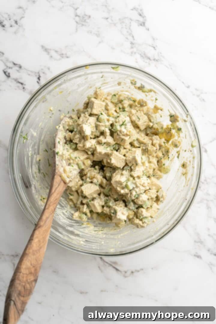 Overhead view of tofu egg salad in mixing bowl