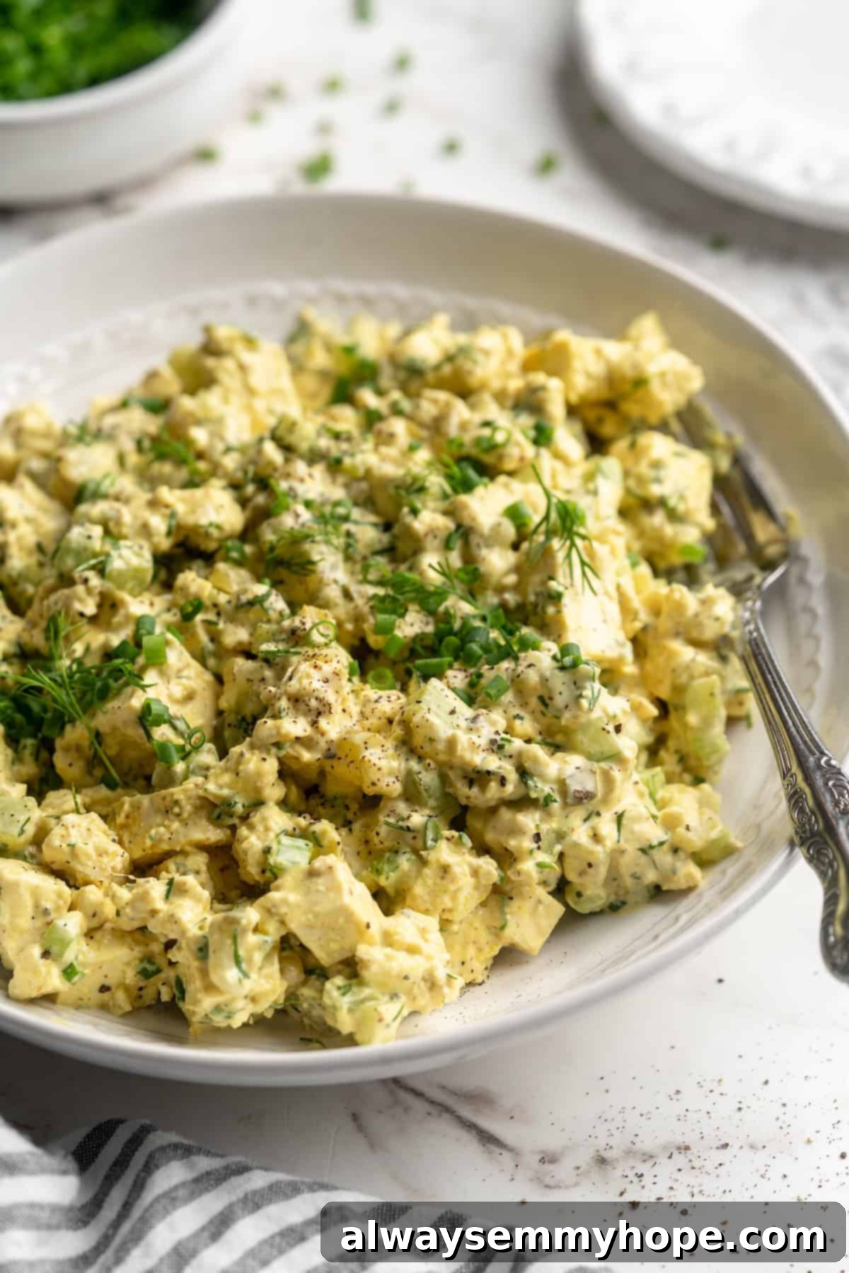 Tofu egg salad in bowl with fork