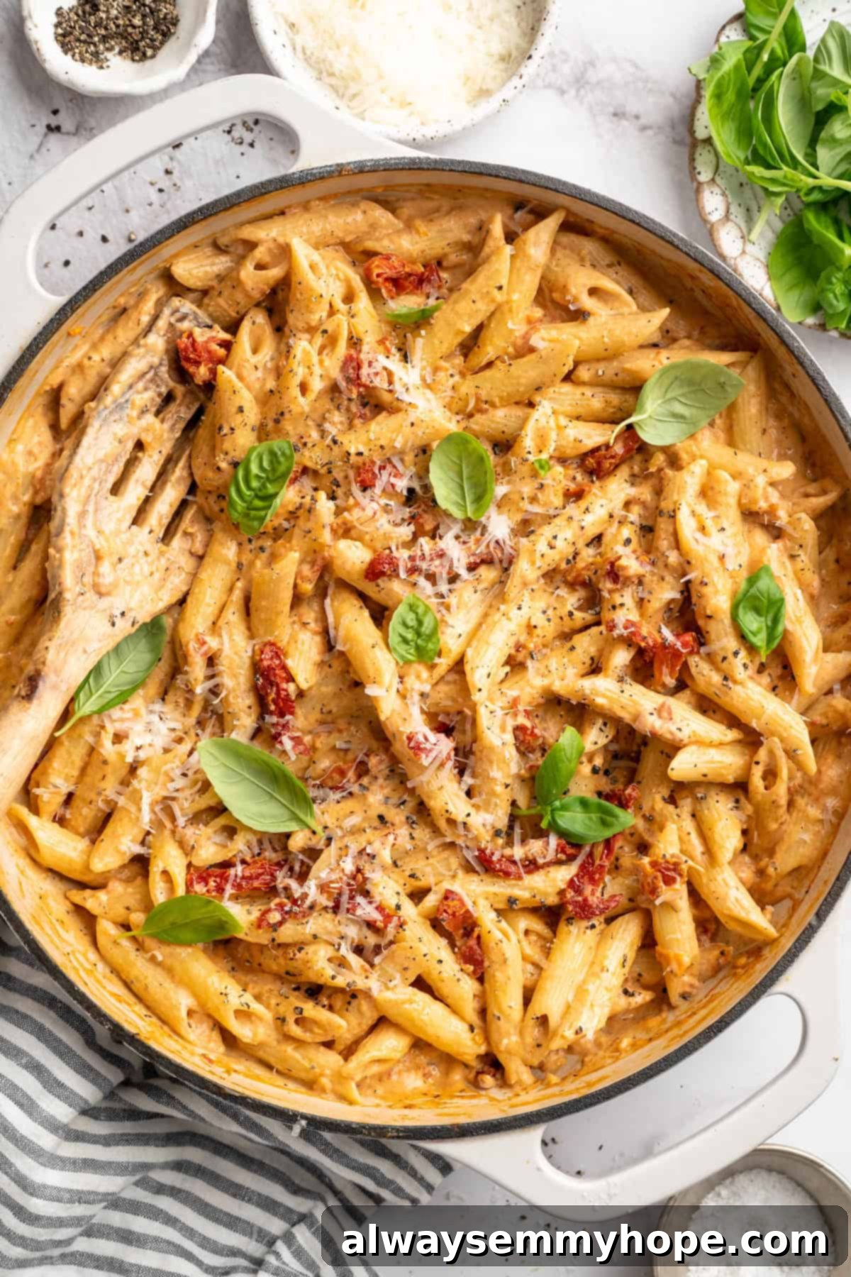 Overhead view of marry me pasta in skillet with slotted spoon