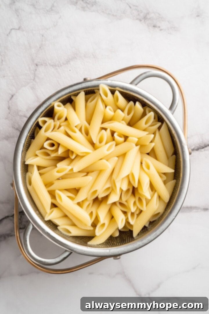 Overhead view of drained penne in colander