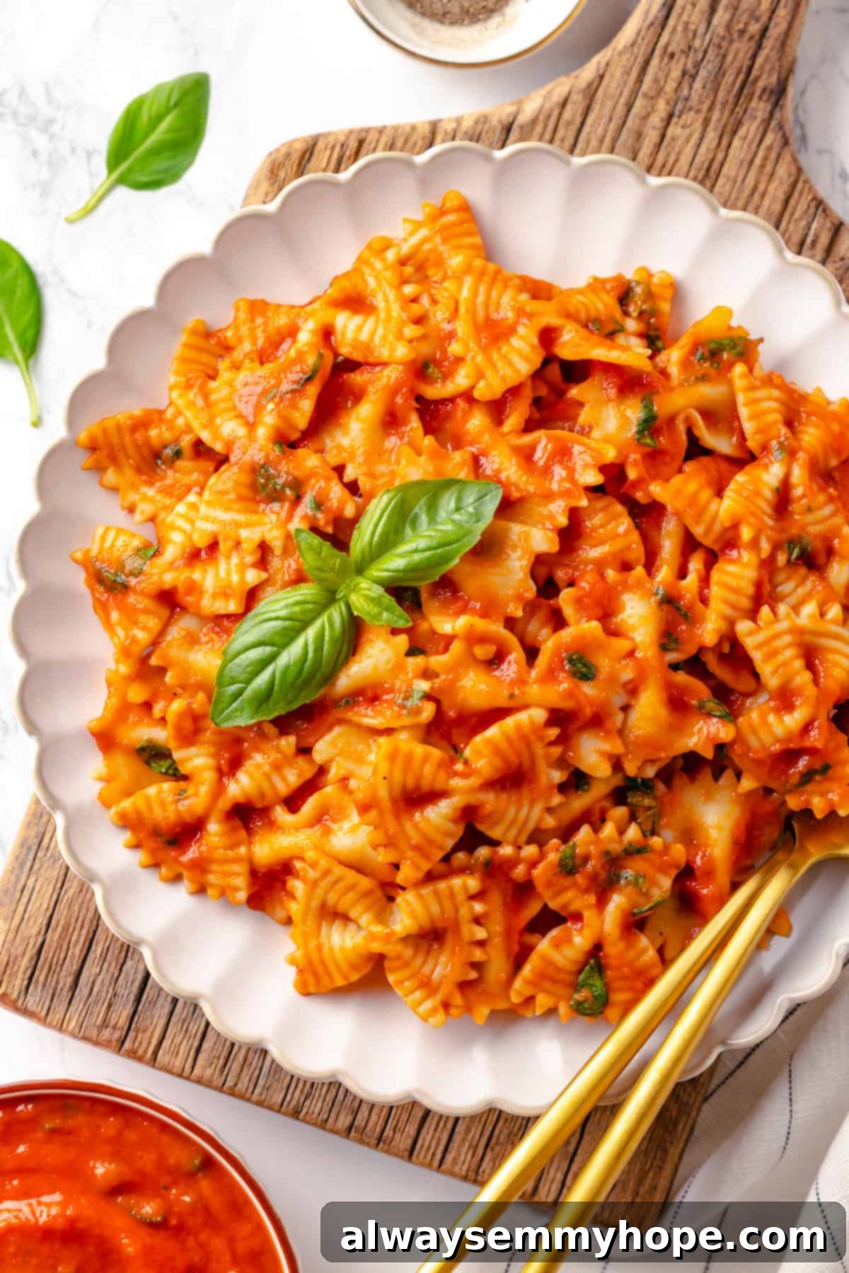 This homemade pomodoro sauce recipe takes a short list of simple ingredients and transforms them into a fresh, vibrant pasta sauce. So easy! Overhead view of pasta with pomodoro sauce on a white plate, ready to be served.