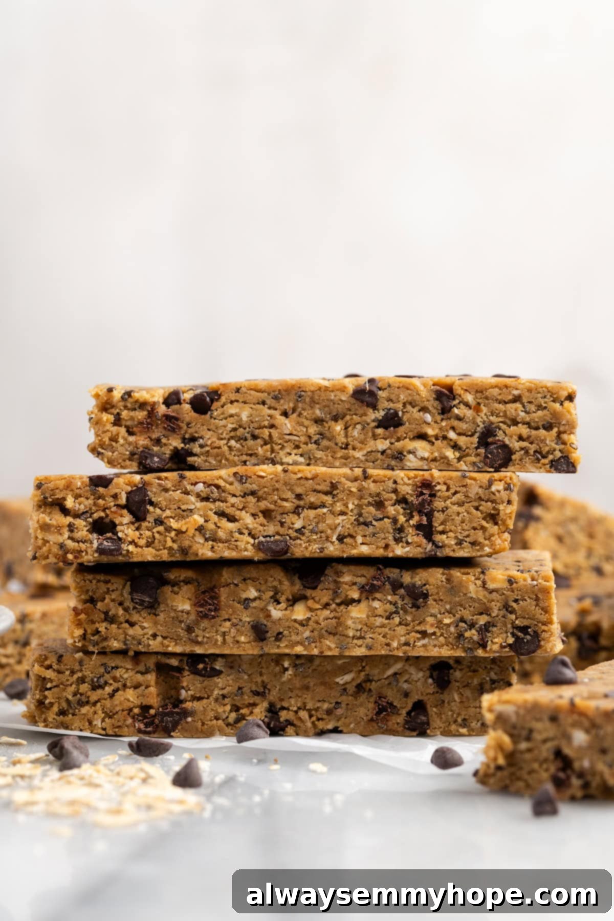 These homemade vegan protein bars are an easy, no-bake recipe that you can customise with your favourite flavours and mix-ins. So tasty! Stack of 4 homemade vegan protein bars showing texture
