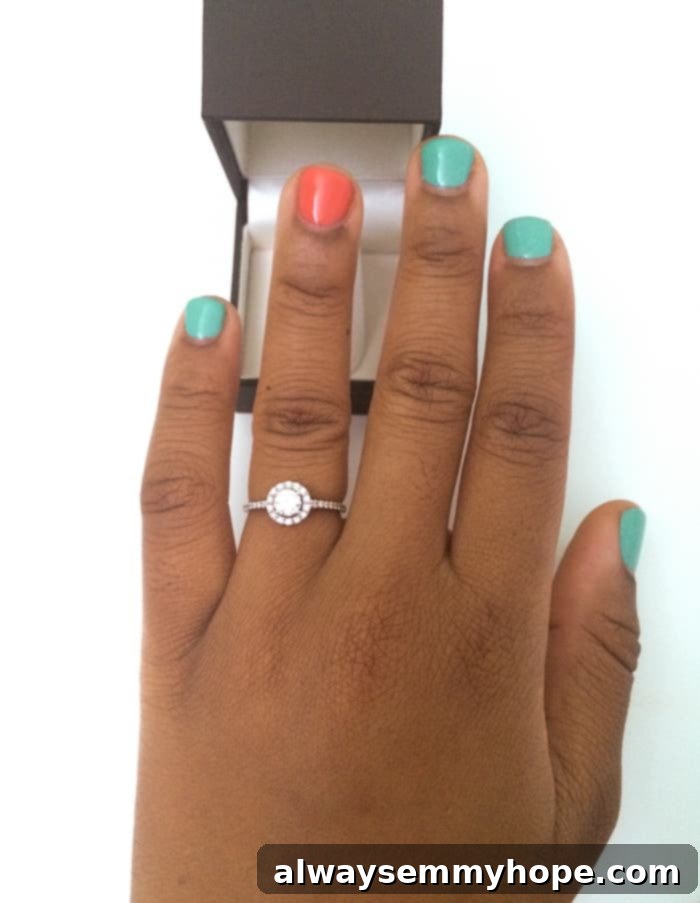 Hand with engagement ring.