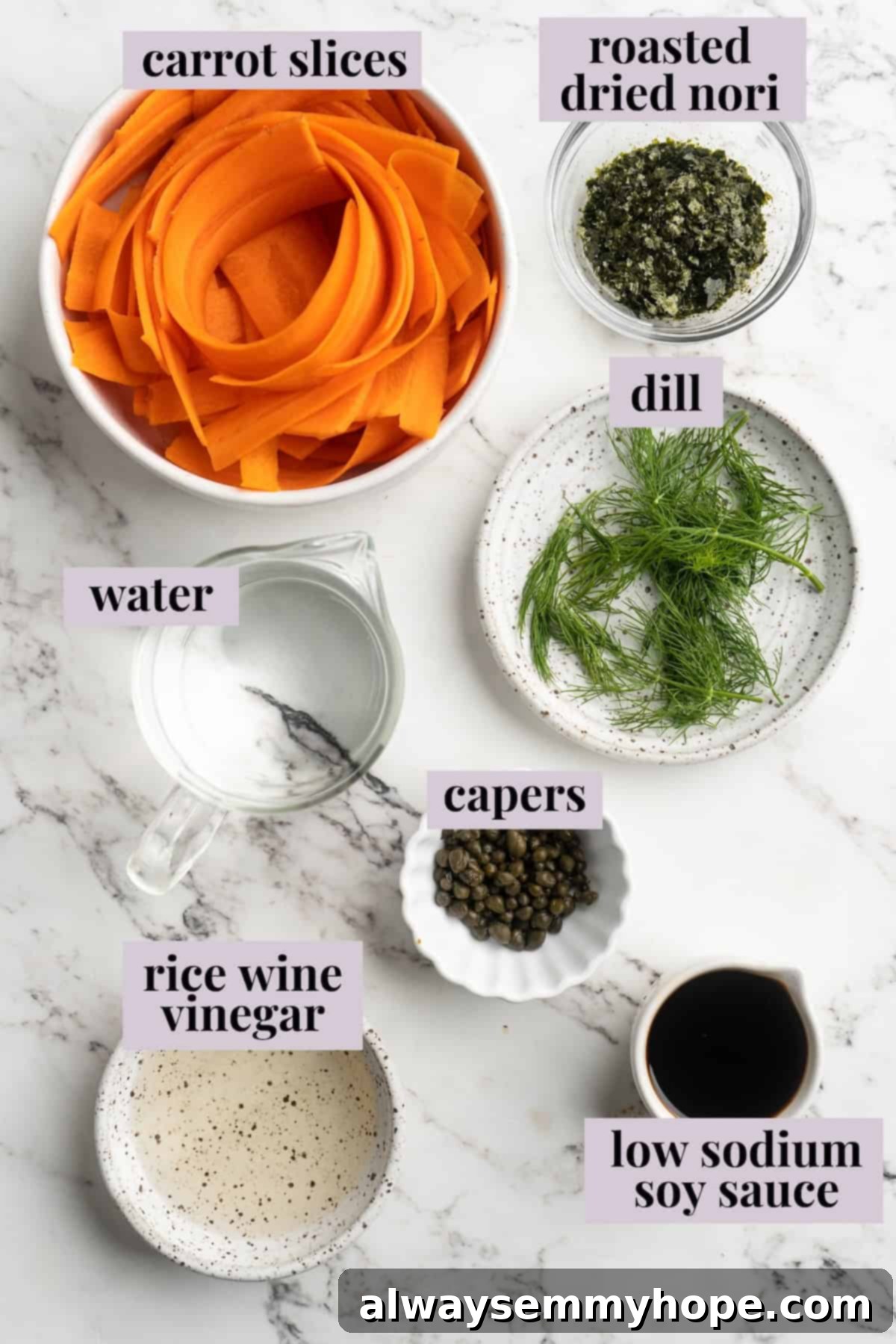 Overhead view of fresh ingredients for carrot lox including large carrots, nori seaweed, rice wine vinegar, and low-sodium soy sauce.