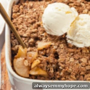Spoon digging into vegan apple crisp in baking dish