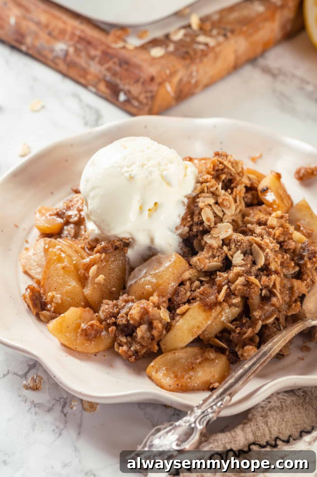 Vegan apple crisp on plate with ice cream