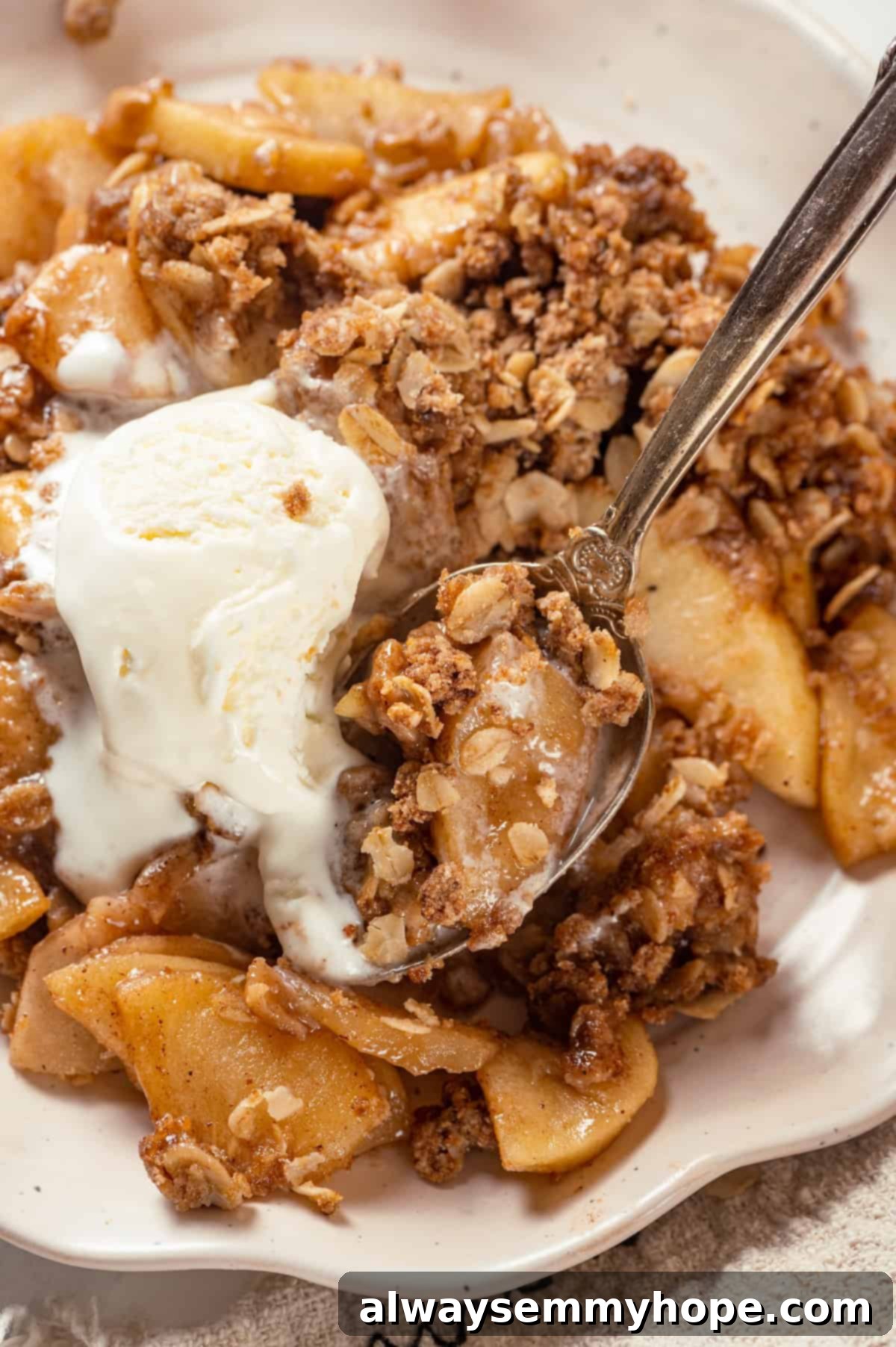Vegan apple crisp on plate with ice cream