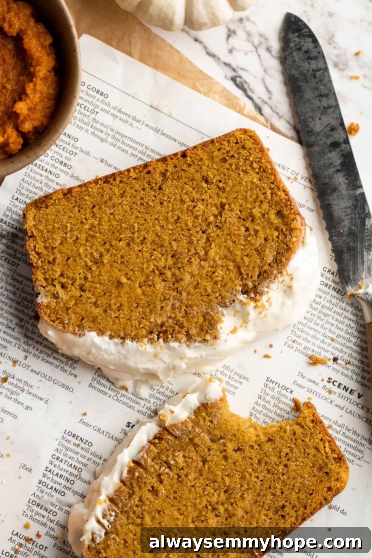 Vegan pumpkin bread with cream cheese frosting is moist, full of cozy spices and the frosting takes it over the top. So easy to make too! Artfully arranged slices of vegan pumpkin bread with a generous layer of cream cheese frosting, ready to be enjoyed.