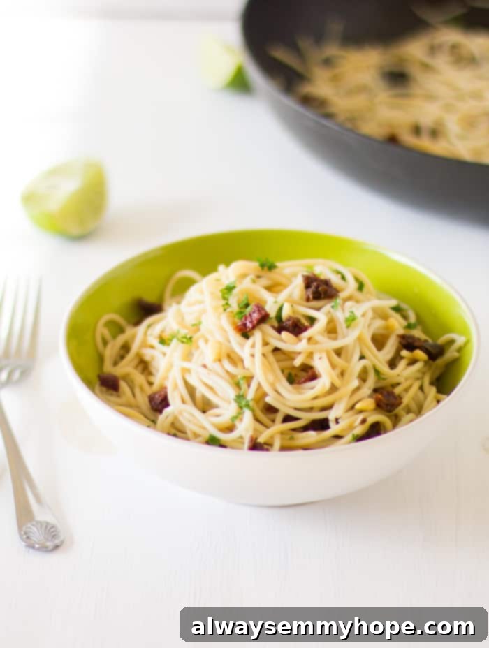 Garden Fresh Lasagna 3 Lemon Garlic Spaghetti in a green bowl with a fork.