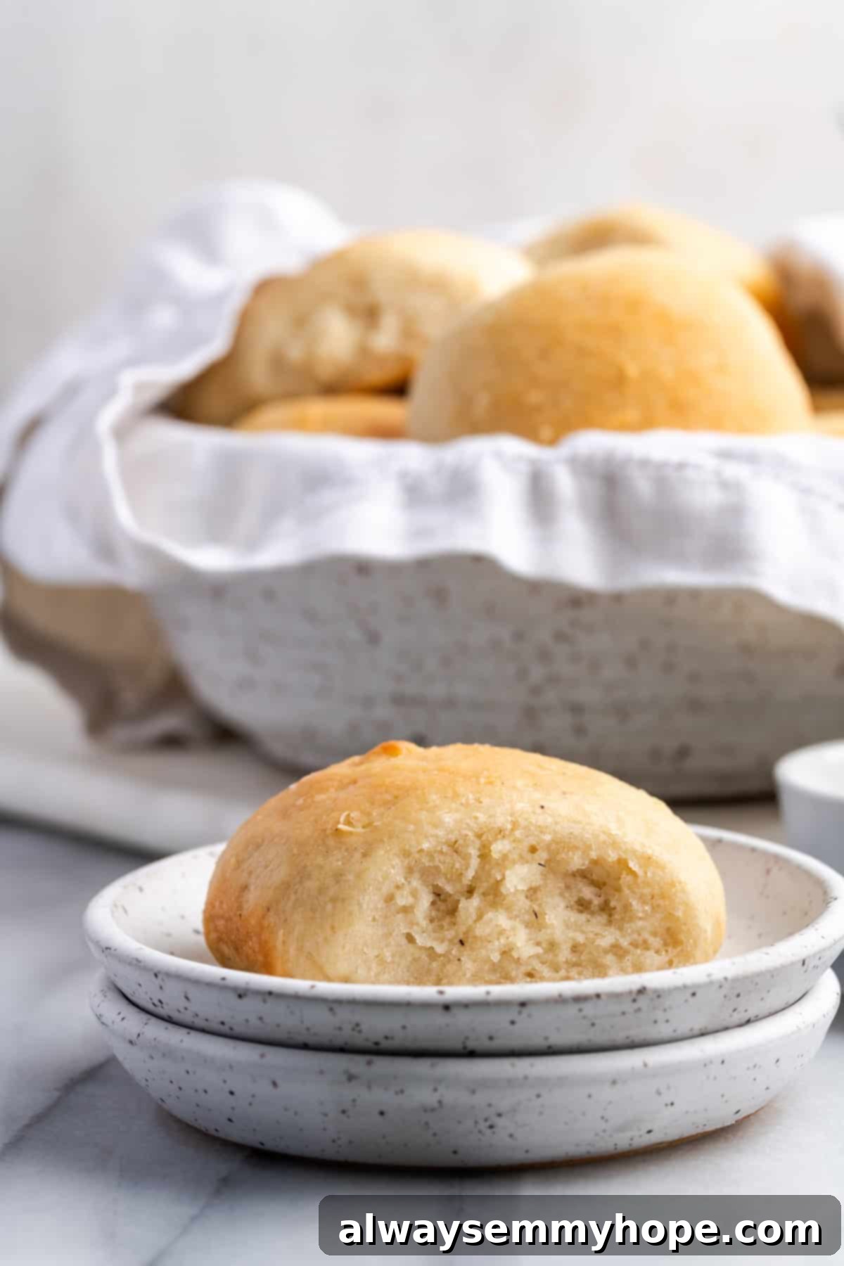 Serving Gluten-Free Vegan Dinner Rolls Two plates of vegan gluten-free dinner rolls, one with butter, the other in a bowl