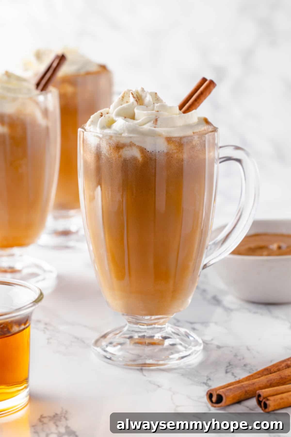 A warm winter cocktail recipe for vegan hot buttered rum, ideal for holiday parties or cozy nights, boasting rich flavors and aromatic spices. A beautifully presented mug of vegan hot buttered rum, topped with fluffy vegan whipped cream and a fragrant cinnamon stick, ready to be enjoyed during the holidays or by a cozy fire.
