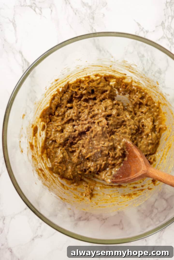A Dubai chocolate bar is filled with crispy kataifi and a rich, creamy mixture of pistachio and tahini. Here’s how to make them at home! Overhead view of Dubai chocolate bar filling in bowl with spoon