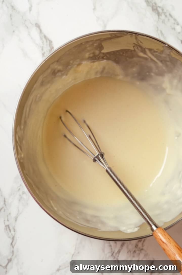 A Dubai chocolate bar is filled with crispy kataifi and a rich, creamy mixture of pistachio and tahini. Here’s how to make them at home! Melted white chocolate in bowl