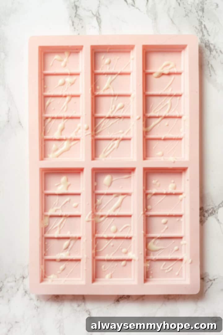 A Dubai chocolate bar is filled with crispy kataifi and a rich, creamy mixture of pistachio and tahini. Here’s how to make them at home! White chocolate drizzled into candy bar mold