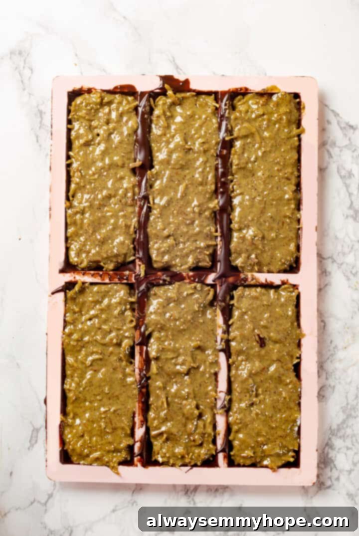 A Dubai chocolate bar is filled with crispy kataifi and a rich, creamy mixture of pistachio and tahini. Here’s how to make them at home! Dubai chocolate bar filling in molds