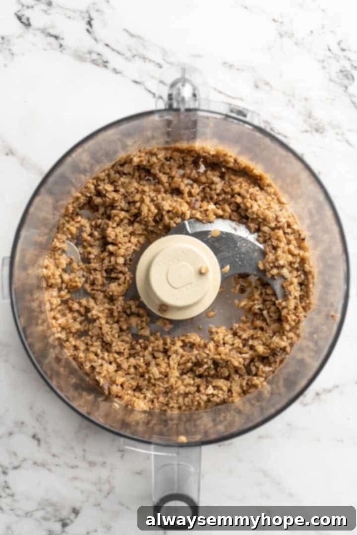 Overhead view of minced walnuts in food processor