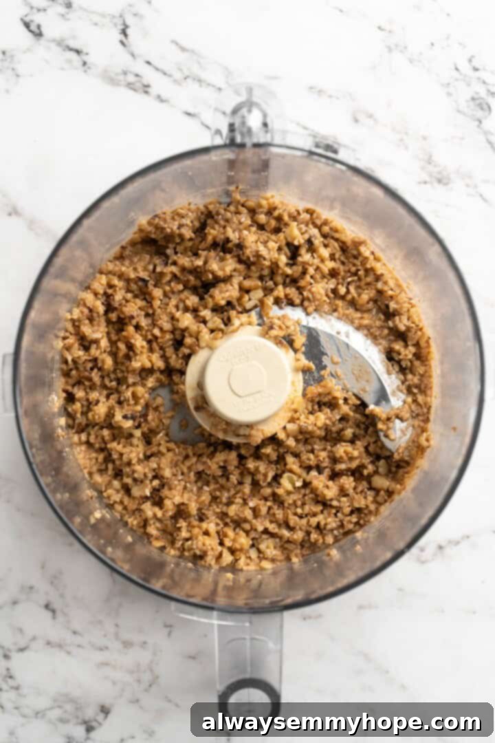 Overhead view of walnut meat in food processor